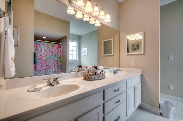 bathroom featuring a shower with shower curtain, tile patterned floors, and vanity