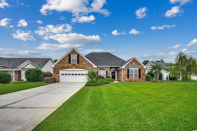 view of front of house featuring a garage and a front lawn