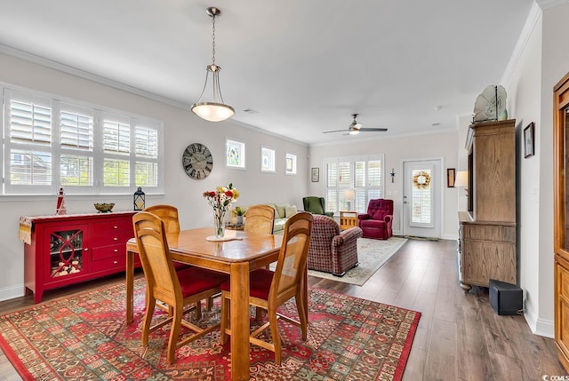 dining space with ceiling fan, crown molding, and hardwood / wood-style floors