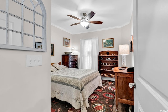 bedroom featuring ornamental molding, hardwood / wood-style floors, and ceiling fan