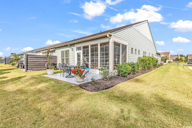 back of property featuring a patio and a yard