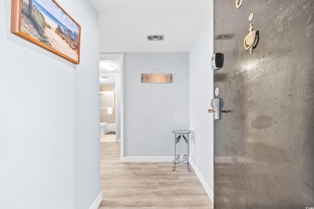 hallway with light wood-type flooring