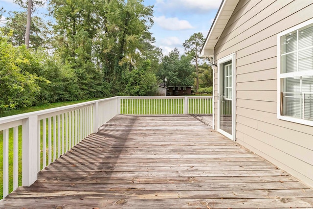 wooden terrace with a lawn