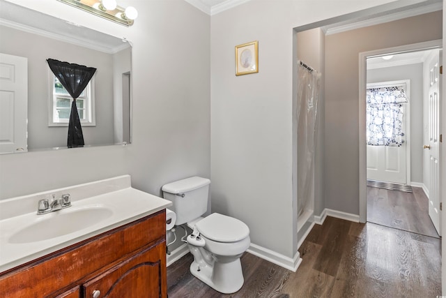 bathroom featuring wood-type flooring, walk in shower, crown molding, vanity, and toilet