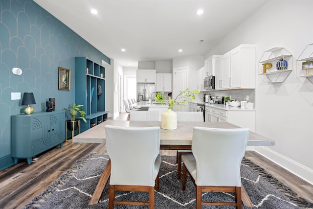 dining room with dark hardwood / wood-style floors and sink