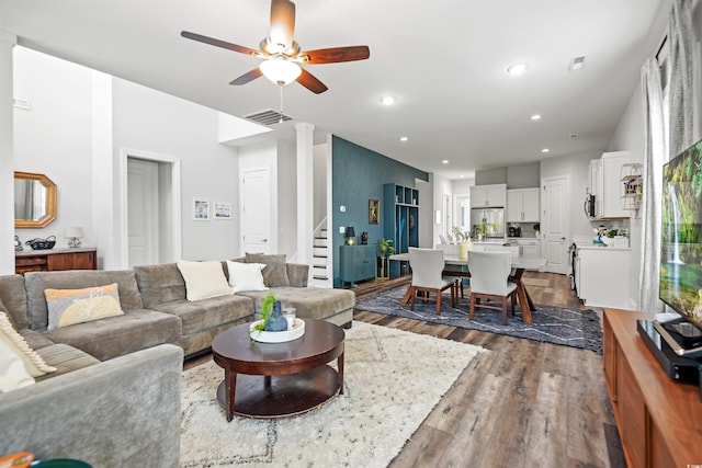 living room with dark wood-type flooring and ceiling fan