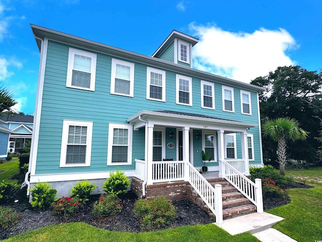 colonial-style house featuring a front lawn and a porch