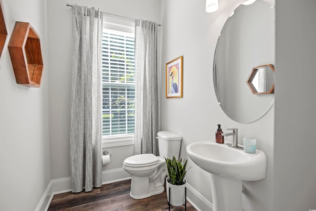 bathroom featuring hardwood / wood-style flooring, toilet, and sink