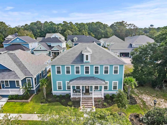 view of front of house with a front yard and covered porch