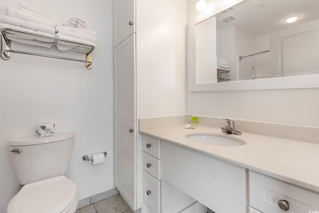 bathroom featuring vanity, toilet, and tile patterned floors