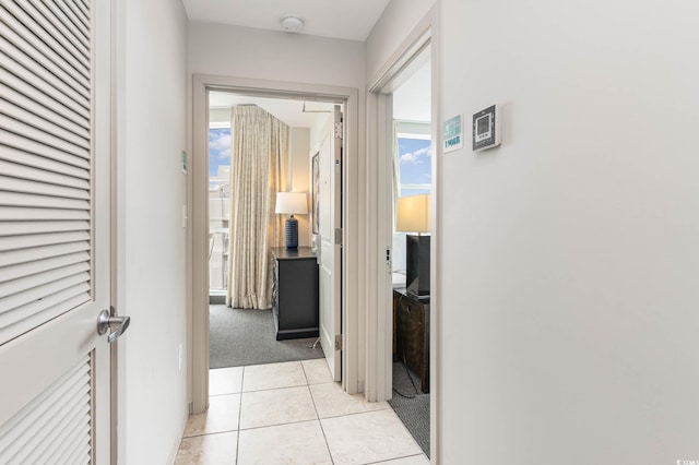 hallway with light colored carpet