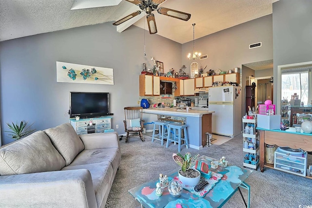 living room featuring light carpet, a textured ceiling, and ceiling fan with notable chandelier