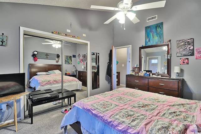 carpeted bedroom with high vaulted ceiling, a closet, ceiling fan, and a textured ceiling