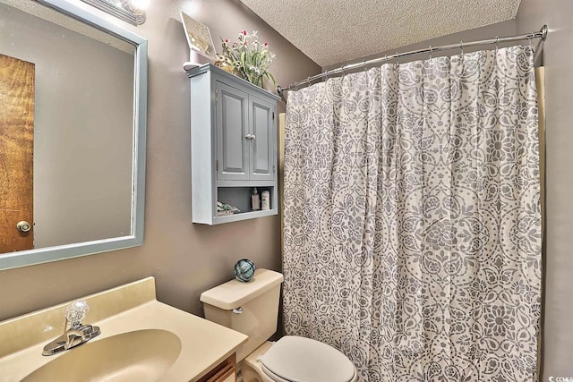 bathroom featuring a textured ceiling, vanity, toilet, and a shower with curtain