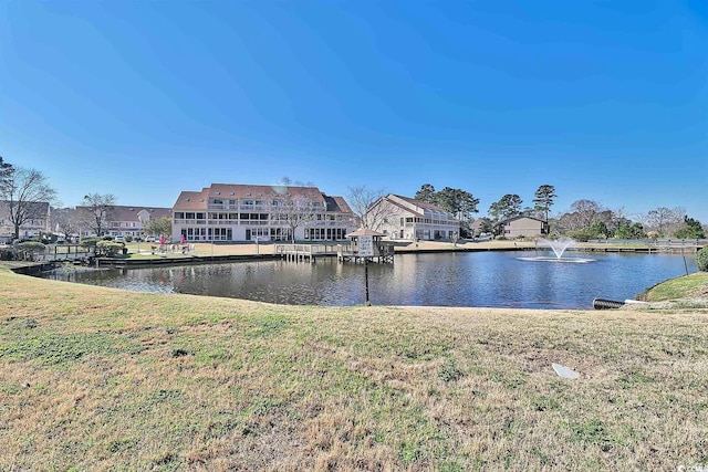 exterior space featuring a lawn and a water view