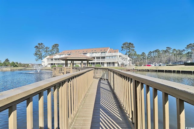 view of dock featuring a gazebo and a water view