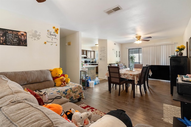 living room with ceiling fan and dark hardwood / wood-style floors