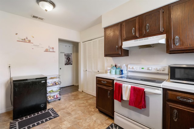 kitchen with dark brown cabinets and white electric range oven