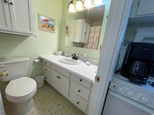 bathroom with walk in shower, washer / clothes dryer, vanity, and toilet