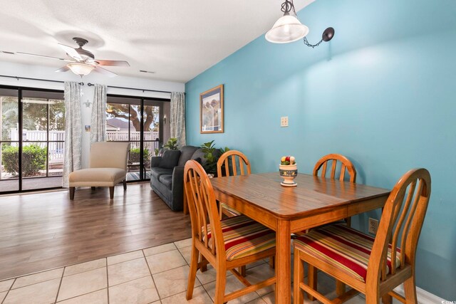 dining area with ceiling fan and light wood-type flooring