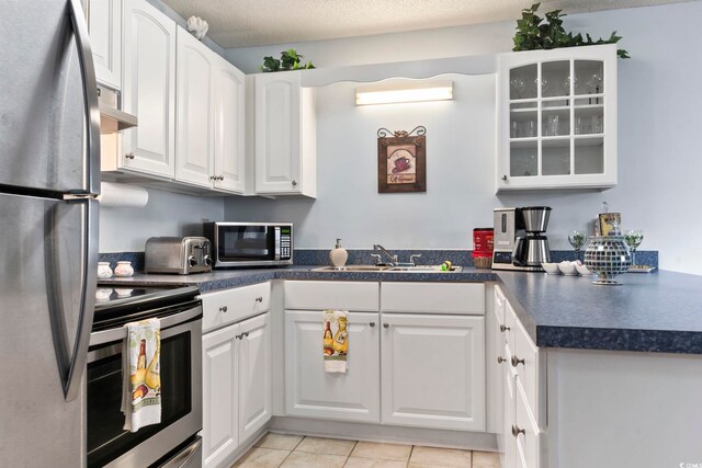 kitchen with stainless steel appliances, white cabinets, ventilation hood, and sink