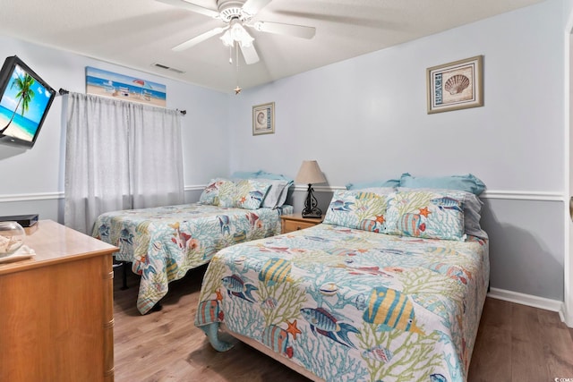 bedroom featuring ceiling fan and light hardwood / wood-style flooring