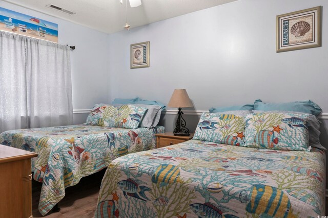 bedroom with ceiling fan and wood-type flooring