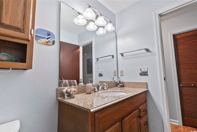 bathroom featuring hardwood / wood-style floors, vanity, and toilet