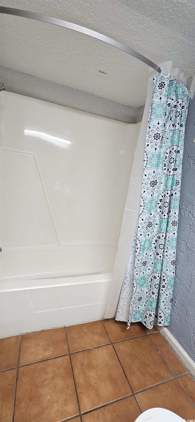 bathroom with tile patterned flooring and shower / bath combo with shower curtain