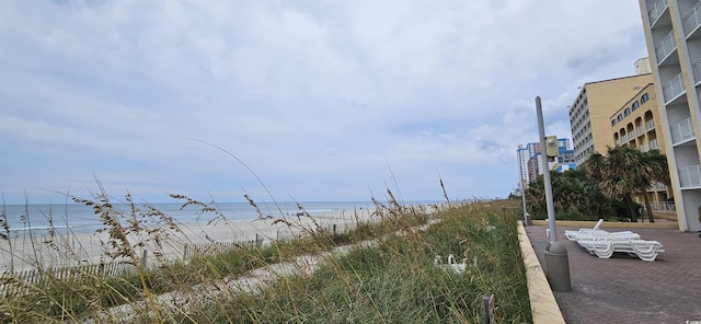 view of road featuring a beach view and a water view