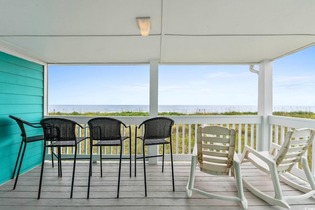 wooden terrace featuring a water view