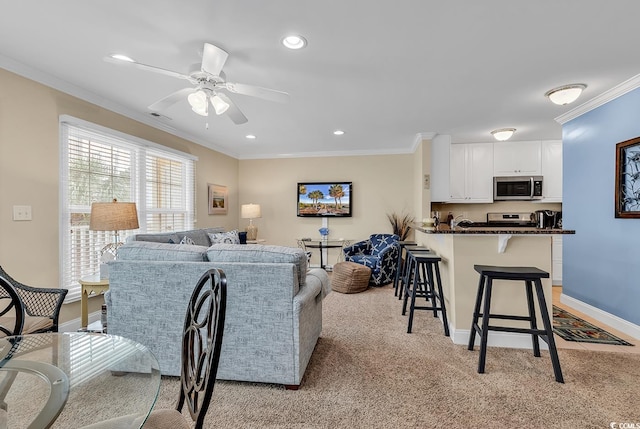 living room featuring light carpet, ornamental molding, and ceiling fan