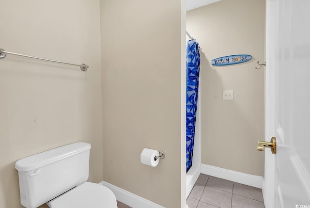 bathroom featuring walk in shower, tile patterned flooring, and toilet