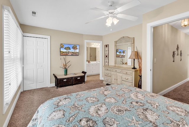 bedroom featuring ensuite bathroom, ceiling fan, light colored carpet, and a closet