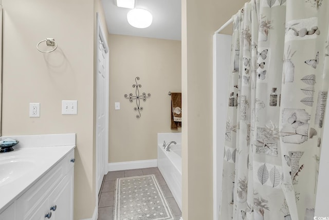 bathroom with tile patterned floors, a bath, and vanity