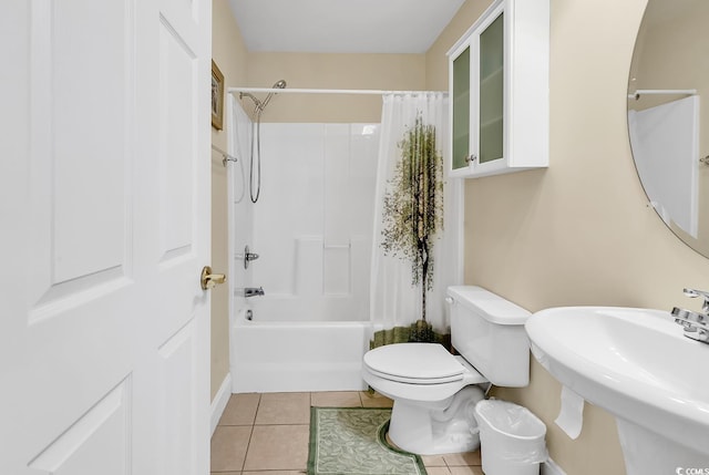 full bathroom featuring shower / bath combination with curtain, tile patterned flooring, sink, and toilet