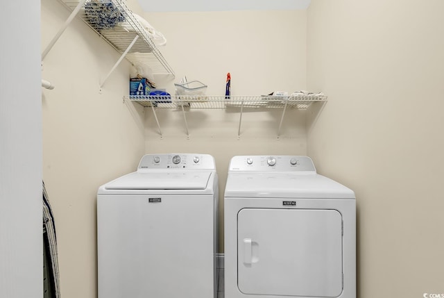 washroom featuring washing machine and dryer