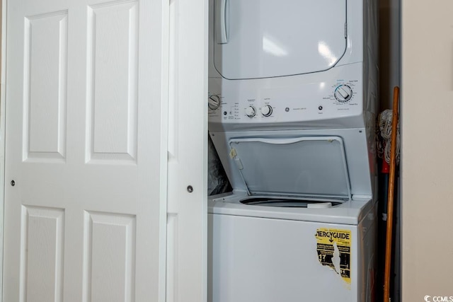 laundry room with laundry area and stacked washer / dryer