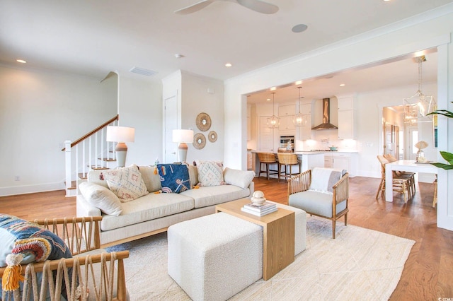 living room featuring a notable chandelier and light wood-type flooring