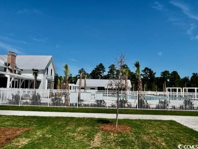 view of pool with a yard