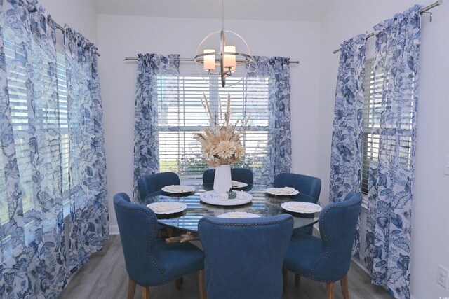 dining room featuring hardwood / wood-style flooring and a chandelier