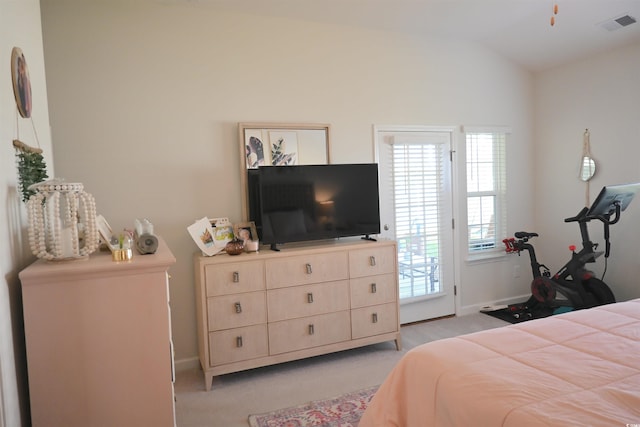 carpeted bedroom with lofted ceiling, multiple windows, and access to exterior