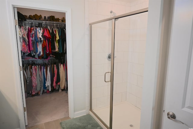 bathroom with tile patterned floors and an enclosed shower