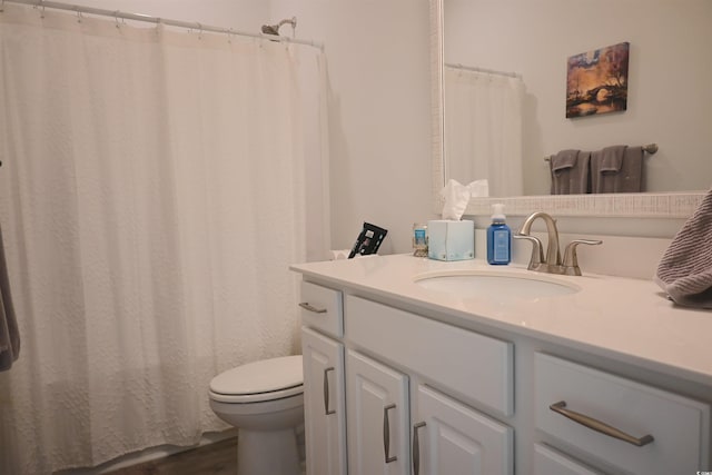 bathroom featuring vanity, hardwood / wood-style floors, curtained shower, and toilet