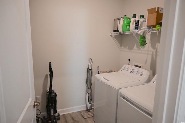 laundry room with hardwood / wood-style flooring and separate washer and dryer