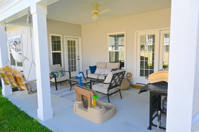 view of patio with an outdoor living space and ceiling fan