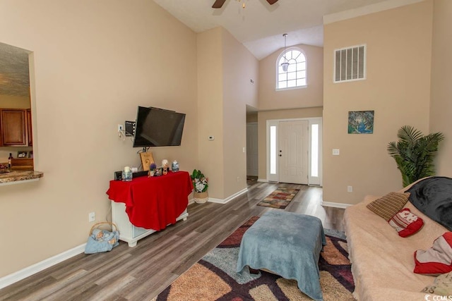 entrance foyer featuring high vaulted ceiling, ceiling fan, and dark hardwood / wood-style floors