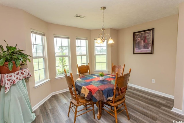 dining area featuring an inviting chandelier and dark hardwood / wood-style floors