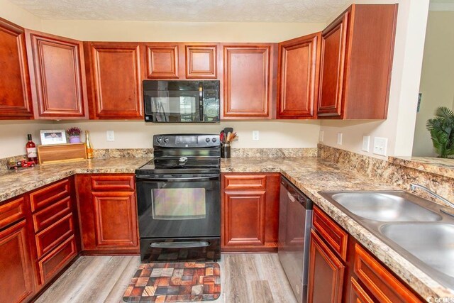 333 Carolina Springs Ct, Conway, SC 29527 - kitchen with dark brown cabinets, a sink, and black appliances