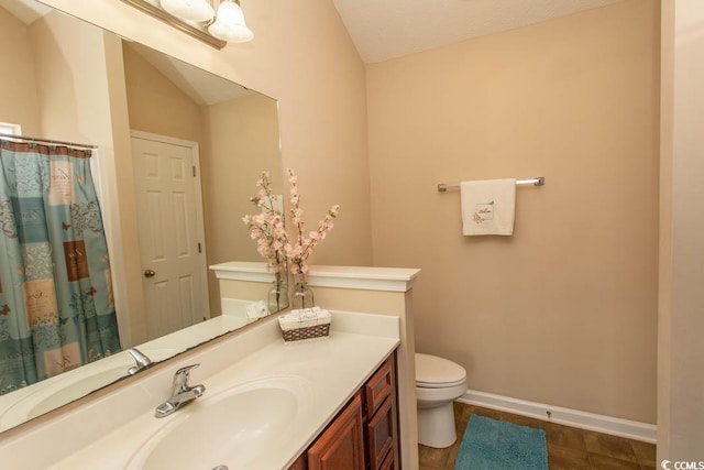 bathroom featuring tile patterned flooring, a textured ceiling, vaulted ceiling, vanity, and toilet